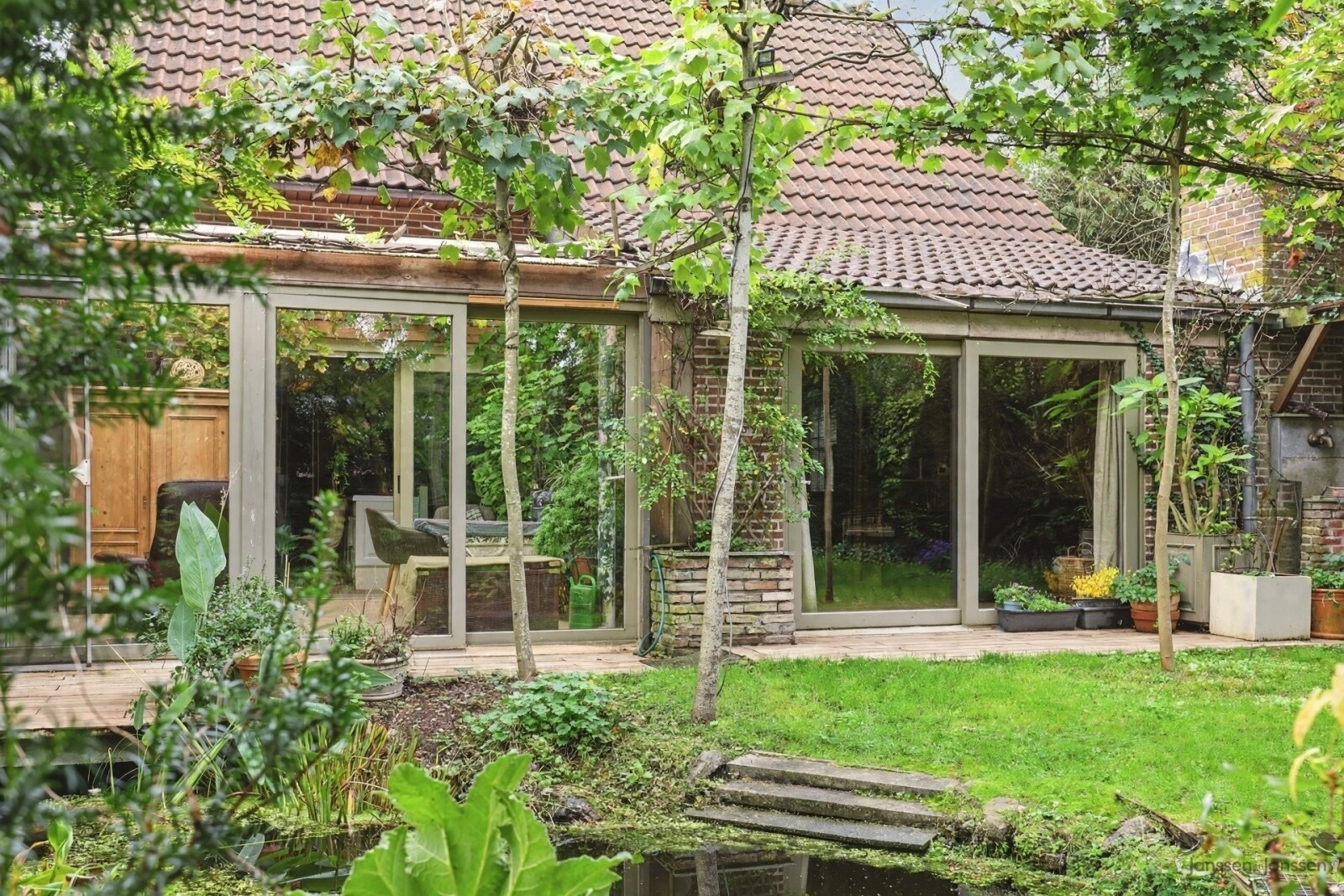 brick-house-with-lush-backyard-garden